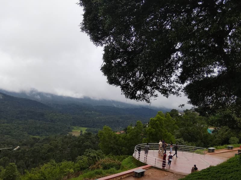 Raja’s Seat Coorg viewpoint with valley and clouds